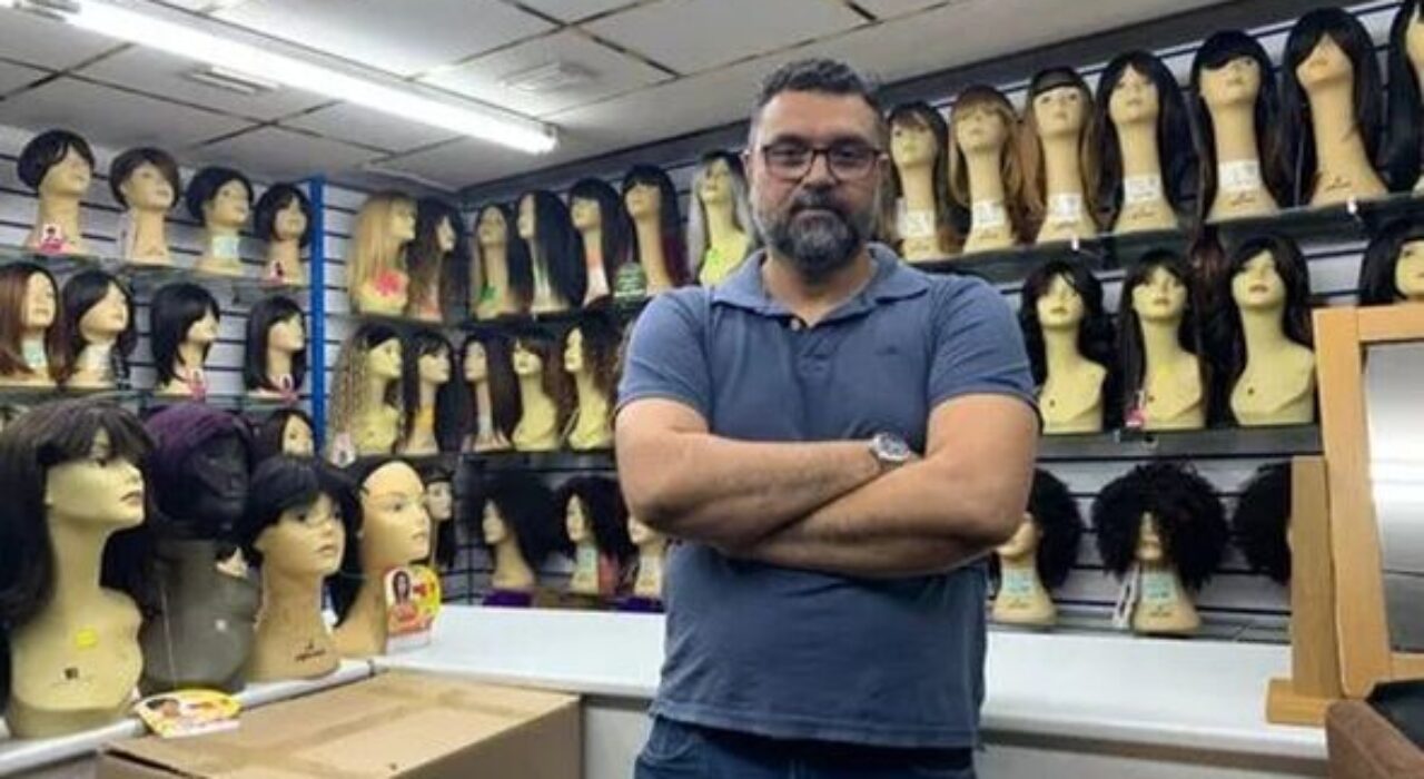 2 A Shopkeeper who is accused of choking a female customer goes into hiding after angry protests