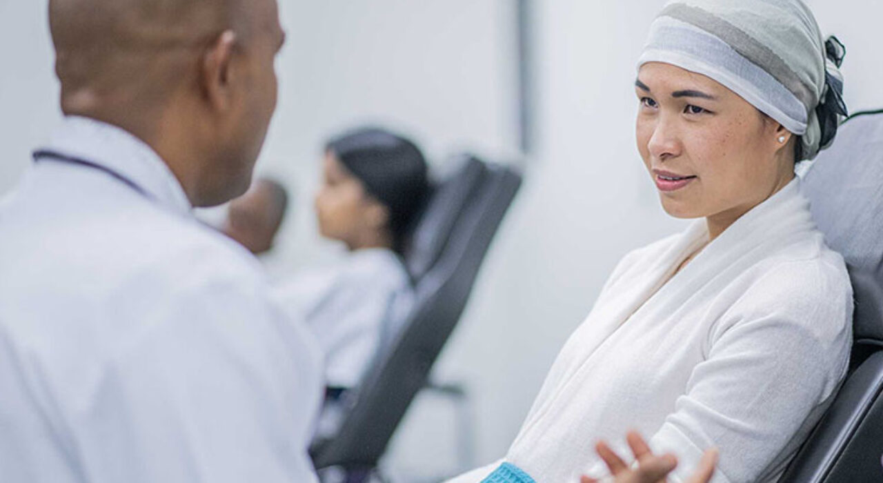 Male Doctor explaining intravenous drip chemotherapy treatment to a female cancer patient