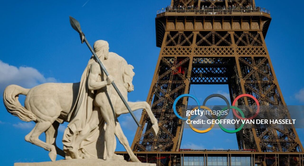 Olympic rings are seen on the Eiffel Tower near the restored statue of "Cavalier Arabe" (Arab rider) on the Pont d'Iena bridge in Paris on July 4, 2024, ahead of the upcoming Paris 2024 Olympic Games. (Photo by GEOFFROY VAN DER HASSELT / AFP) (Photo by GEOFFROY VAN DER HASSELT/AFP via Getty Images)