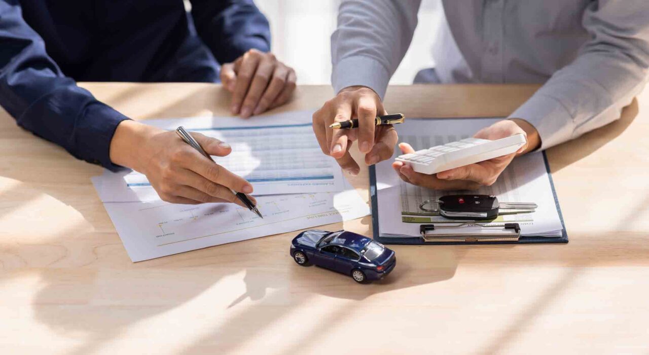Dealer salesman giving car key to owner. client signing insurance document or rental car lease form agreement contract Insurance car concept.